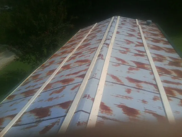 Rusted metal roof panels with new wood purlins before replacement — Storm Damage Roof Repair in Lake Panasoffkee by Roofing Brothers